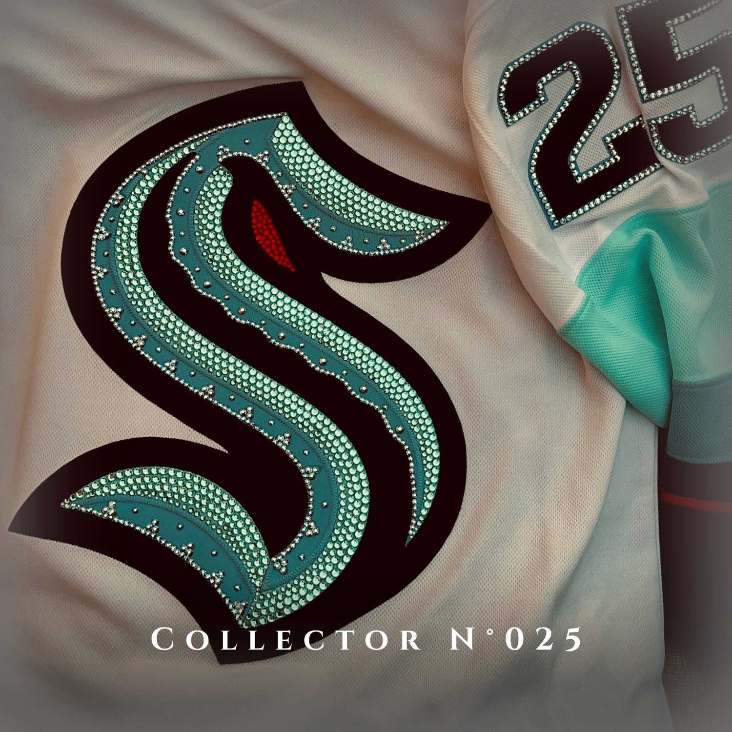 Custom Rhinestone Jersey: Seattle Kraken Away jersey with hand applied crystals to the crest and number 25.Displayed as Collector N⁰ 025. 